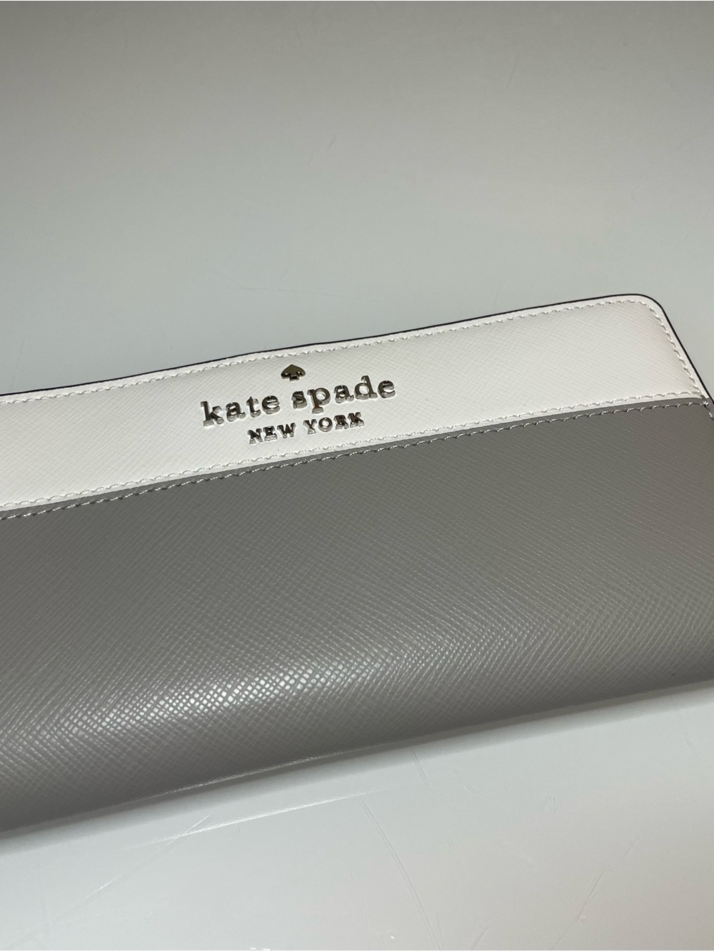 kate spade Two-Tone White and Light Gray Saffiano Zip Wallet with Gold Logo
